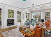 Thumbnail 33 of 50 - A living room with a fireplace and a couch.