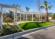 Thumbnail 47 of 50 - A white pergola is over a green lawn.