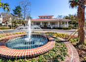 Thumbnail 50 of 50 - A fountain in the middle of a brick circle.