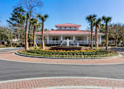 Thumbnail 49 of 50 - A house with a red roof and a fountain in front.