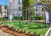 Thumbnail 27 of 50 - A playground with a swing set and a blue frame.