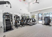 Thumbnail 30 of 50 - A gym with treadmills, elliptical machines, and other cardio equipment.