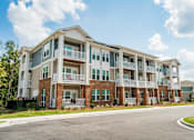 Thumbnail 31 of 31 - A large apartment community with multiple balconies and doors.