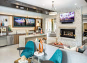 Thumbnail 7 of 31 - A clubroom with fireplace and entertainment with ample seating.