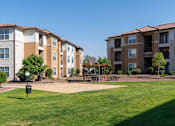 Thumbnail 26 of 41 - Apartment complex with a basketball court in front.