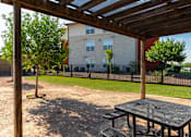 Thumbnail 27 of 41 - A wooden pergola over a picnic table in a park.
