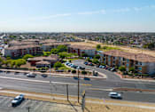 Thumbnail 41 of 41 - A view of a city from a high vantage point with buildings, cars, and a clear sky.