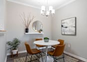 Thumbnail 4 of 41 - A dining room with a white table and chairs.