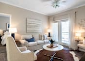 Thumbnail 5 of 41 - A living room with a white couch, a white chair, a white coffee table, a white rug, a white ceiling fan, a white wall, a white door, a white floor, a white table, a white lamp, a white