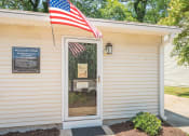 Thumbnail 11 of 13 - the front door of the welcome center with an flag