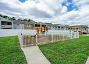 Thumbnail 7 of 30 - a yard with a swing set in front of houses