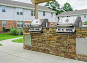 Thumbnail 17 of 30 - a brick outdoor kitchen with two grills on it