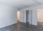 Thumbnail 25 of 30 - an empty living room with white walls and a closet