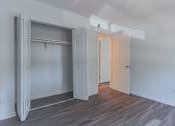 Thumbnail 23 of 30 - an empty bedroom with a closet and a door to a bathroom