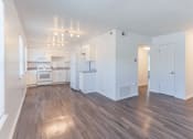 Thumbnail 21 of 30 - the living room and kitchen in a new home with white walls and wood flooring
