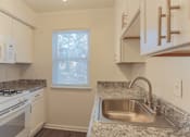 Thumbnail 27 of 30 - a kitchen with a sink and a stove and a window