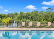 Thumbnail 20 of 35 - Pool with lake view at Bermuda Estates Apartments in Ormond Beach, FL