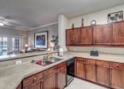 Thumbnail 8 of 35 - Kitchen with ample cabinets and dishwasher at Bermuda Estates Apartments in Ormond Beach, FL