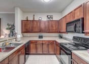 Thumbnail 9 of 35 - Large kitchen with double sinks at Bermuda Estates Apartments in Ormond Beach, FL