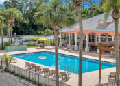 Thumbnail 19 of 35 - Large resort-style pool and covered patio at Bermuda Estates Apartments in Ormond Beach, FL