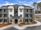 Thumbnail 47 of 50 - an exterior view of new apartments and large parking lot at Tapestry Overbrook in McDonough, Georgia