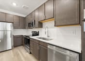 Thumbnail 5 of 50 - kitchen with custom cabinets and goose-neck faucet at Tapestry Overbrook in McDonough, Georgia