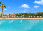 Thumbnail 2 of 35 - Swimming pool and sundeck at Bermuda Estates Apartments in Ormond Beach, FL