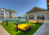 Thumbnail 24 of 34 - a resort style pool with lounge chairs and grassy area