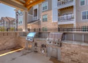 Thumbnail 28 of 34 - an outdoor kitchen with stainless steel appliances