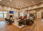 Thumbnail 17 of 34 - a large living room with a fireplace and hardwood floors