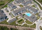Thumbnail 32 of 34 - an aerial view of a large apartment complex with a swimming pool