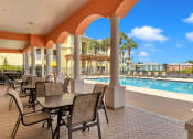 Thumbnail 21 of 35 - Pool and pergola with covered patio at Bermuda Estates Apartments in Ormond Beach, FL