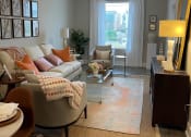 Thumbnail 8 of 29 - Open concept living area with patio access at Flats on 4th Apartments in Birmingham, AL