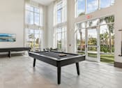 Thumbnail 32 of 39 - the pool table in the clubhouse at Tapestry Headwaters Apartments in Kissimmee, FL