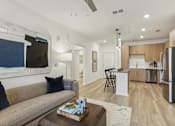 Thumbnail 8 of 39 - open-concept living area with wood designed flooring at Tapestry Headwaters in Kissimmee, FL
