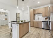 Thumbnail 5 of 39 - Island Kitchen with Pendant Lighting at Tapestry Headwaters in Kissimmee, FL