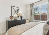 Thumbnail 15 of 39 - a bedroom with a large bed and a large window at Tapestry Headwaters in Kissimmee, FL