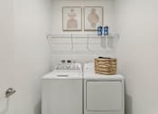 Thumbnail 20 of 39 - laundry room with full-size washer and dryer at Tapestry Headwaters in Kissimmee, FL