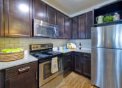 Thumbnail 3 of 54 - Modern Kitchen with Stainless Appliances at 4700 Colonnade Apartments in Birmingham, AL