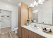 Thumbnail 12 of 39 - Modern bathroom with ample storage, large vanity, and luxury vinyl plank flooring at Tapestry Headwaters in Kissimmee, FL