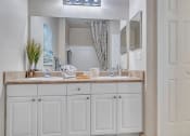 Thumbnail 13 of 35 - bathroom with cabinets and large vanity at Bermuda Estates Apartments in Ormond Beach, FL