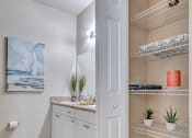 Thumbnail 12 of 35 - bathroom with tile floor and linen closet at Bermuda Estates Apartments in Ormond Beach, FL