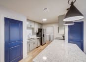 Thumbnail 1 of 28 - a renovated kitchen with blue doors and white cabinets