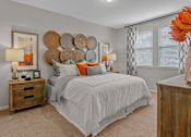 Thumbnail 7 of 38 - a bedroom with a bed and nightstand