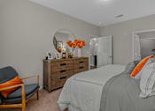 Thumbnail 8 of 38 - a bedroom with a bed and a dresser and a mirror