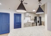 Thumbnail 7 of 28 - a kitchen with blue doors and a white counter top
