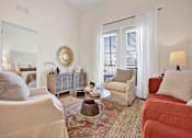 Thumbnail 8 of 55 - Model Apartment living room with high ceilings and glass patio doorsair.