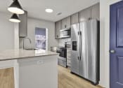 Thumbnail 9 of 28 - a renovated kitchen with stainless steel appliances and a counter top