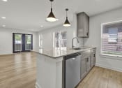 Thumbnail 3 of 28 - an open kitchen and living room with a large counter top