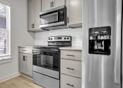 Thumbnail 5 of 28 - a kitchen with stainless steel appliances and white cabinets